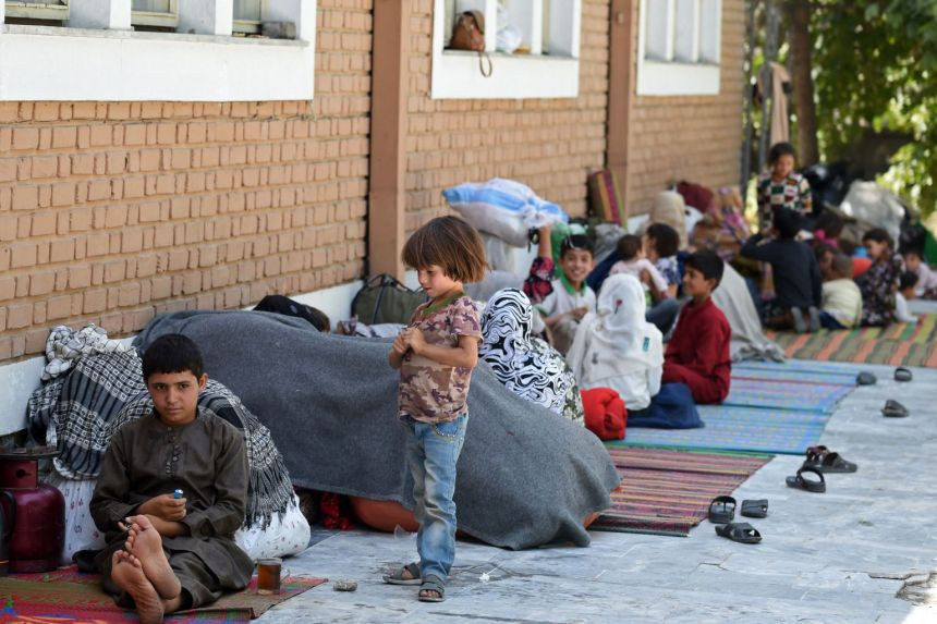 internally displaced afghan families who fled fighting in the north sit in the courtyard of the wazir akbar khan mosque in kabul on aug 13 2021 photo afp