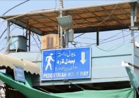 a sign with a cross showing the pedestrian walk way is seen at the key border crossing as trucks carrying goods destined for afghanistan line up following clashes between security forces of pakistan and afghanistan in torkham photo anadolu