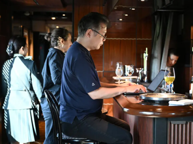 Toh EnJoe, a master of Japanese science-fiction, sipped a glass of wine as he wrote. PHOTO: AFP