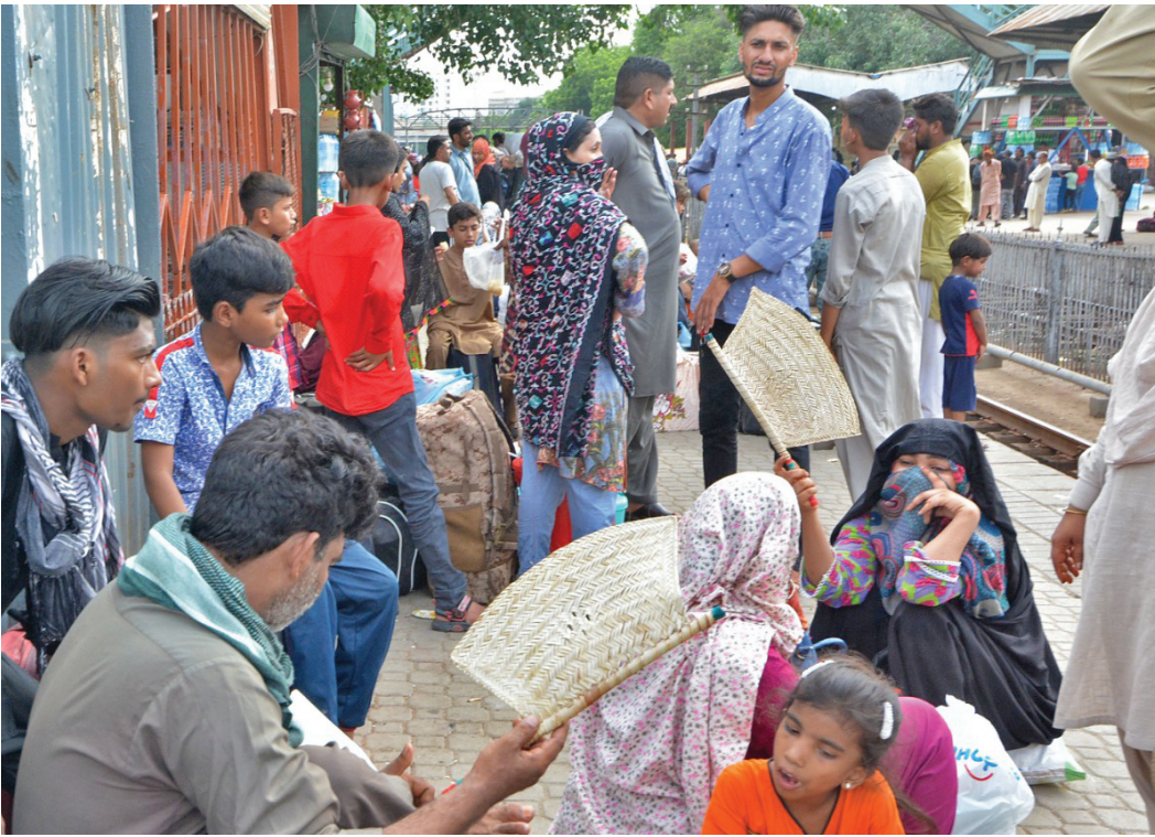 stranded passengers wait for their train at karachi cantt station train timings have been disrupted due to flooding of tracks following rains in the province photo jalal qureshi express