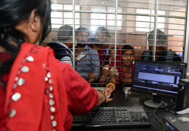 A passenger pays for a ticket at the Gandhinagar railway station in Jaipur. PHOTO: AFP