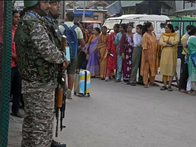 indian security personnel stand guard as hindu pilgrims await their registration ahead of the the annual amarnath pilgrimage tauseef mustafa afp
