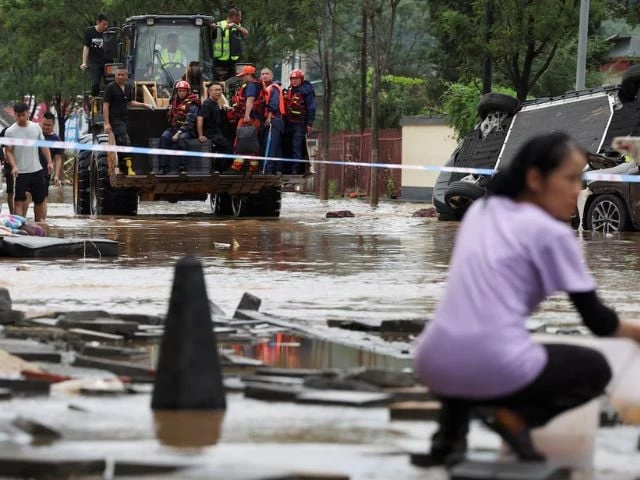 rescue workers ride on a front loader as they make their way through a flooded road behind a cordon line after heavy rainfall in miyun district of beijing china july 29 2025 reuters florence lo purchase licensing rights rescue workers ride on a front loader as they make their way through a flooded road behind a cordon line after heavy rainfall in miyun district of beijing china july 29 2025 reuters florence lo purchase licensing rights