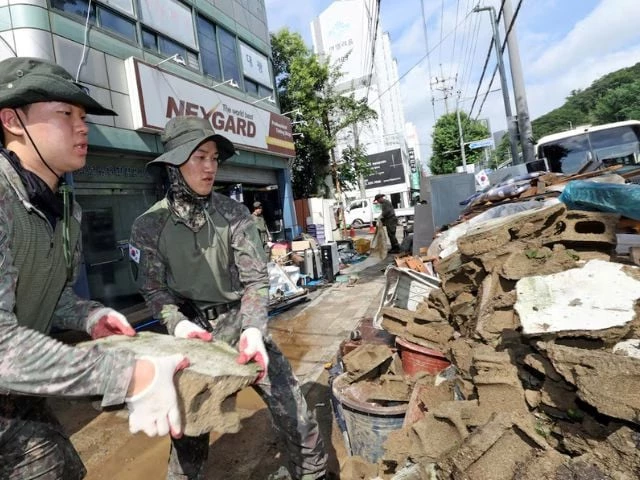 south korean soldiers move debris from an area that was flooded by torrential rain in gwangju south korea july 20 2025 yonhap via reuters