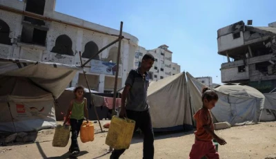 displaced palestinian man akram al manasra and his children make their way to collect water from a distribution point amid shortages in gaza city july 14 2025 reuters dawoud abu alkas