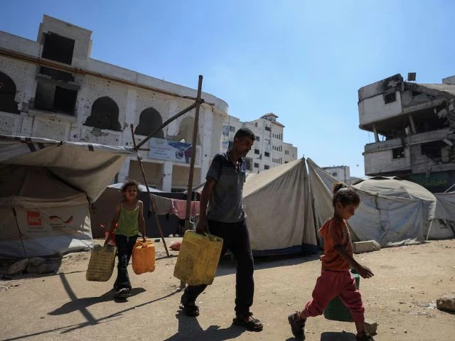 displaced palestinian man akram al manasra and his children make their way to collect water from a distribution point amid shortages in gaza city july 14 2025 reuters dawoud abu alkas displaced palestinian man akram al manasra and his children make their way to collect water from a distribution point amid shortages in gaza city july 14 2025 reuters dawoud abu alkas