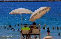 lifeguards watch beachgoers as they bathe at the beach of catalans on a sunny and warm summer day in marseille as an early summer heatwave hits france july 1 2025 reuters manon cruz
