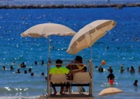 lifeguards watch beachgoers as they bathe at the beach of catalans on a sunny and warm summer day in marseille as an early summer heatwave hits france july 1 2025 reuters manon cruz