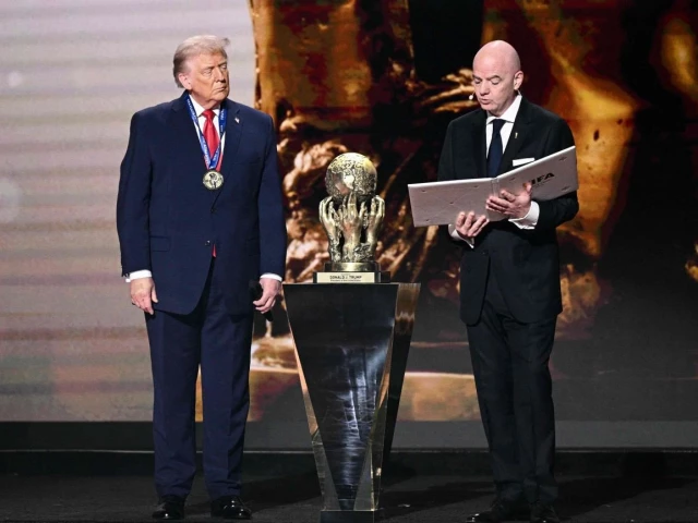 us president donald trump looks on as he receives the fifa peace prize from fifa president gianni infantino during the draw for the 2026 fifa football world cup taking place in the us canada and mexico at the kennedy center in washington dc on december 5 2025 photo afp