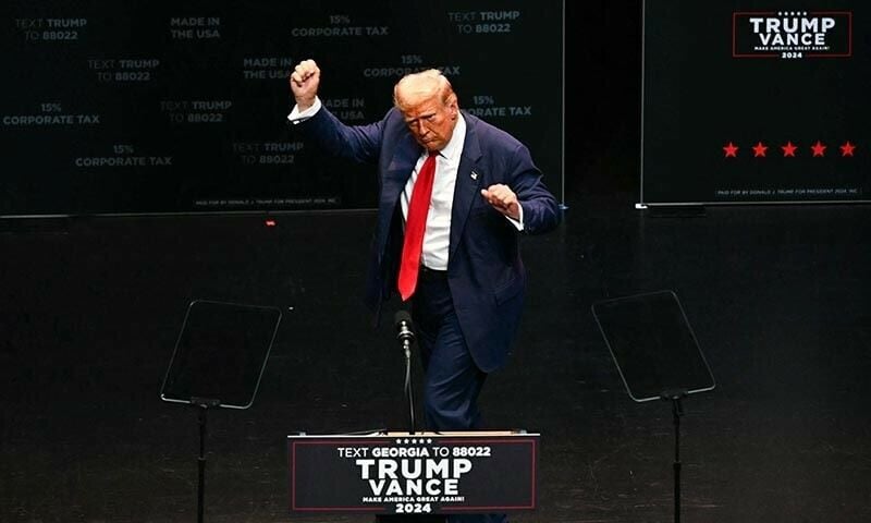 former us president and republican presidential candidate donald trump dances onstage as he concludes his remarks at a campaign rally in savannah georgia on september 24 afp