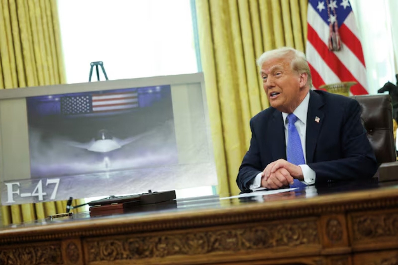 u s president donald trump delivers remarks as an image of an f 47 sixth generation fighter jet is displayed in the oval office at the white house march 21 2025 photo reuters