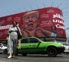 a woman walks near a billboard depicting us president donald trump on a building in tehran iran july 27 2026 wana via reuters