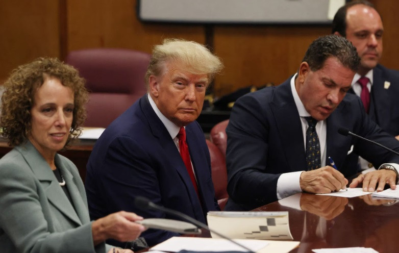 former u s president donald trump is accompanied by members of his legal team susan necheles and joe tacopina as he appears in court for an arraignment on charges stemming from his indictment by a manhattan grand jury april 4 2023 reuters andrew kelly