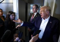 us president donald trump speaks to reporters as u s treasury secretary scott bessent stands next to him aboard air force one en route to tokyo japan for the second stop on his asia tour photo reuters