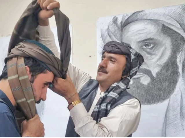a man ties turban on the head of a fellow participant during a ceremony to celebrate pashtun culture day in quetta photo express a man ties turban on the head of a fellow participant during a ceremony to celebrate pashtun culture day in quetta photo express