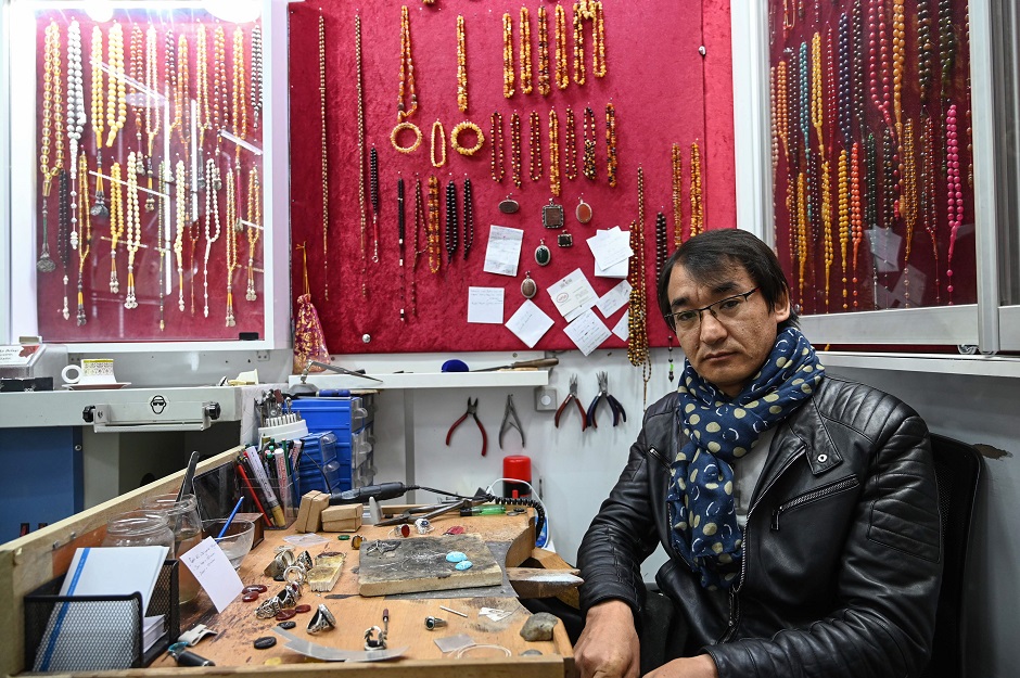 Hadi Ekhlas, engraver, poses for a picture on April 11, 2019 at his workshop in the Grand Bazaar, in Istanbul. PHOTO: AFP