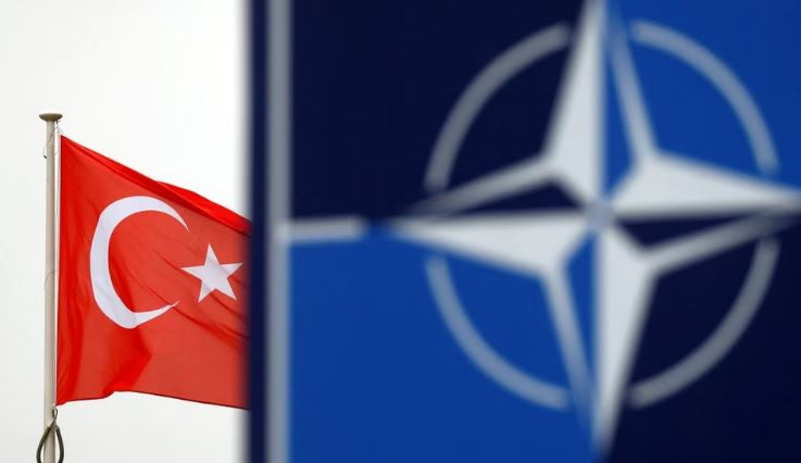 a turkish flag flies next to nato logo at the alliance headquarters in brussels belgium november 26 2019 photo reuters