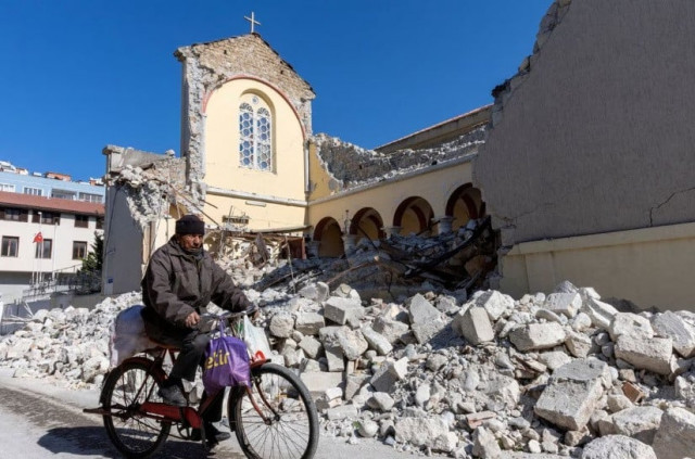 a man rides his bike along a collapsed roman catholic church in the aftermath of the deadly earthquake in iskenderun a coastal town of hatay province turkey february 14 2023 reuters umit bektas file photo a man rides his bike along a collapsed roman catholic church in the aftermath of the deadly earthquake in iskenderun a coastal town of hatay province turkey february 14 2023 reuters umit bektas file photo