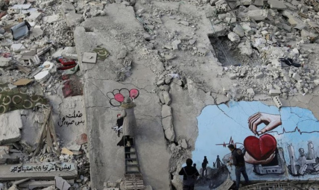 syrian artists aziz asmar and salam hamed paint street art on the rubble of damaged buildings in the aftermath of a deadly earthquake in the rebel held town of jandaris syria february 22 2023 reuters khalil ashawi syrian artists aziz asmar and salam hamed paint street art on the rubble of damaged buildings in the aftermath of a deadly earthquake in the rebel held town of jandaris syria february 22 2023 reuters khalil ashawi