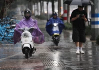 people ride electric scooters in the rain as typhoon bavi approaches in wenzhou zhejiang province china july 11 2026 photo reuters
