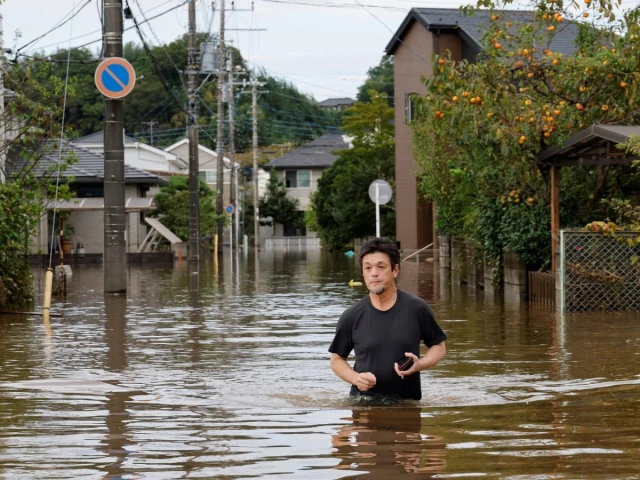 a man wades through a flooded road after typhoon dujuan brought torrential rain to sakura chiba prefecture japan september 22 2026 photo reuters a man wades through a flooded road after typhoon dujuan brought torrential rain to sakura chiba prefecture japan september 22 2026 photo reuters