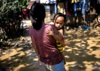 cherry lyn cerdoncillo 22 carrying her son jovani 1 walks in muddy water in the aftermath of flooding caused by typhoon kalmaegi outside their home in consolacion cebu philippines november 6 2025 photo reuters cherry lyn cerdoncillo 22 carrying her son jovani 1 walks in muddy water in the aftermath of flooding caused by typhoon kalmaegi outside their home in consolacion cebu philippines november 6 2025 photo reuters