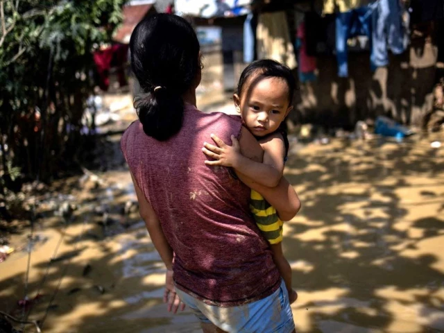 cherry lyn cerdoncillo 22 carrying her son jovani 1 walks in muddy water in the aftermath of flooding caused by typhoon kalmaegi outside their home in consolacion cebu philippines november 6 2025 photo reuters cherry lyn cerdoncillo 22 carrying her son jovani 1 walks in muddy water in the aftermath of flooding caused by typhoon kalmaegi outside their home in consolacion cebu philippines november 6 2025 photo reuters