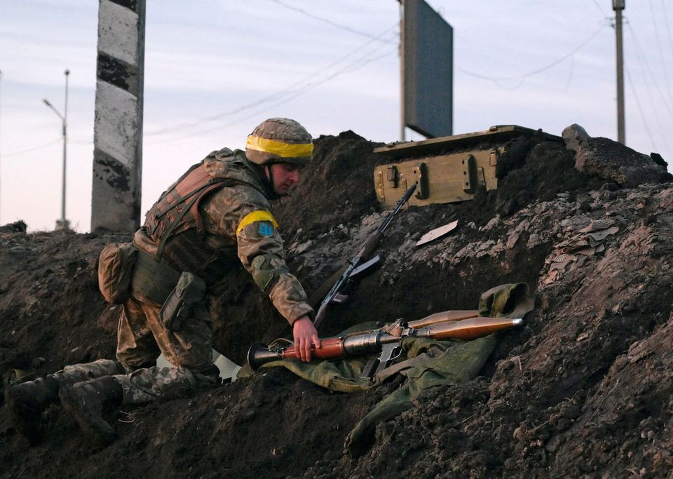 a ukrainian serviceman holds a rocket propelled grenade rpg launcher at fighting positions outside the city of kharkiv ukraine photo reuters