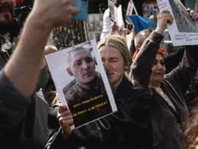 desperate ukrainian families hold up photos of missing soldiers as the latest prisoner of war exchange is carried out between ukraine and russia photo afp desperate ukrainian families hold up photos of missing soldiers as the latest prisoner of war exchange is carried out between ukraine and russia photo afp