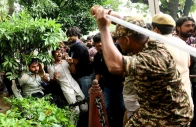 a security force personnel wields his baton against demonstrators at a protest site during a planned march by supporters of india s cockroach janta party towards parliament on the opening day of its monsoon session demanding the resignation of education minister dharmendra pradhan over exam paper leaks near jantar mantar new delhi india july 20 2026 reuter