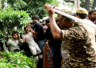 a security force personnel wields his baton against demonstrators at a protest site during a planned march by supporters of india s cockroach janta party towards parliament on the opening day of its monsoon session demanding the resignation of education minister dharmendra pradhan over exam paper leaks near jantar mantar new delhi india july 20 2026 reuter a security force personnel wields his baton against demonstrators at a protest site during a planned march by supporters of india s cockroach janta party towards parliament on the opening day of its monsoon session demanding the resignation of education minister dharmendra pradhan over exam paper leaks near jantar mantar new delhi india july 20 2026 reuter