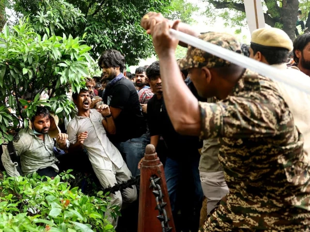 a security force personnel wields his baton against demonstrators at a protest site during a planned march by supporters of india s cockroach janta party towards parliament on the opening day of its monsoon session demanding the resignation of education minister dharmendra pradhan over exam paper leaks near jantar mantar new delhi india july 20 2026 reuter a security force personnel wields his baton against demonstrators at a protest site during a planned march by supporters of india s cockroach janta party towards parliament on the opening day of its monsoon session demanding the resignation of education minister dharmendra pradhan over exam paper leaks near jantar mantar new delhi india july 20 2026 reuter