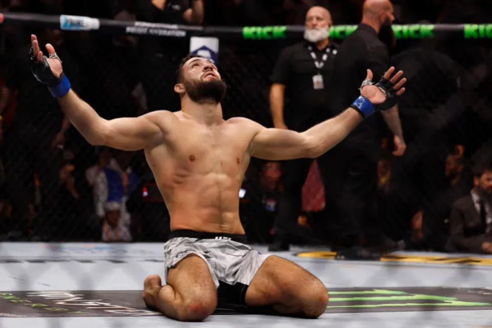 Nassourdine Imanov drops to his knees in celebration at the end of the fight. Photo: Reuters