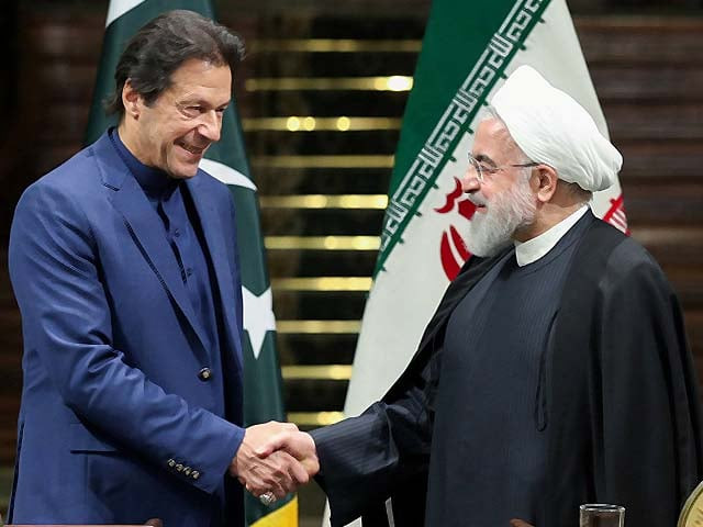 hassan rouhani shakes hands with imran khan photo afp
