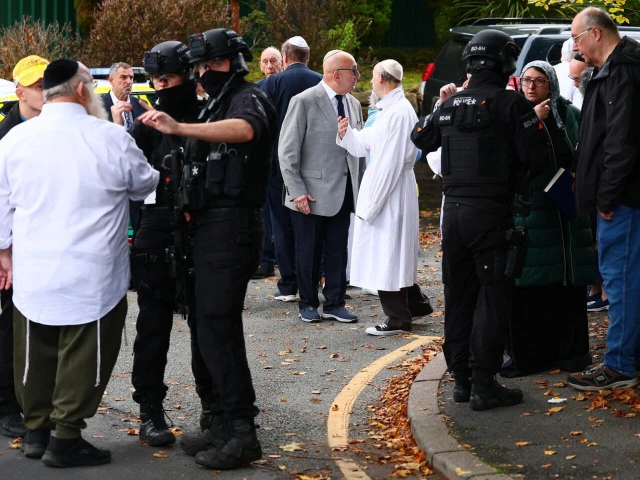 armed police officers near the heaton park hebrew congregation synagogue in crumpsall northern manchester on october 2 2025 photo afp