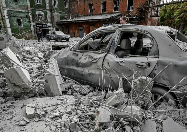 a woman stands near her destroyed car near an old mill built around 1885 also destroyed during a russian missile attack in zaporizhzhia ukraine october 14 2022 photo reuters a woman stands near her destroyed car near an old mill built around 1885 also destroyed during a russian missile attack in zaporizhzhia ukraine october 14 2022 photo reuters