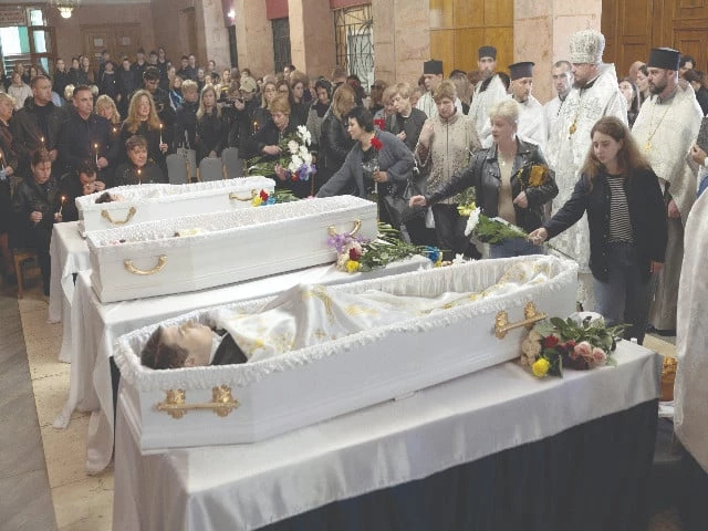 people lay flowers at the coffins of three children who were killed in a russian missile strike in korostyshiv ukraine photo reuters people lay flowers at the coffins of three children who were killed in a russian missile strike in korostyshiv ukraine photo reuters