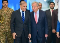 prime minister shehbaz sharif and united nations secretary general antonio guterres walk along a corridor at the prime minister s house before their meeting in islamabad on wednesday photo pmo