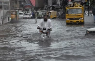 a man rides on a motorcycle amid flood waters along a road during the monsoon season in rawalpindi pakistan july 19 2023 photo reuters