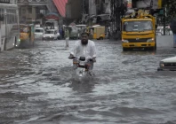 a man rides on a motorcycle amid flood waters along a road during the monsoon season in rawalpindi pakistan july 19 2023 photo reuters