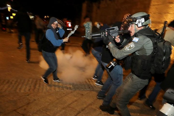 israeli police officer stands in position as a stun grenade explodes by the gate to jerusalem s old city during clashes as the holy fasting month of ramadan continues in jerusalem april 24 2021 reuters