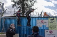 people standing on a fence look at heavy machinery demolishing a structure inside the headquarters of the united nations relief and works agency unrwa in the sheikh jarrah neighbourhood of israeli annexed east jerusalem on january 20 2026 photo afp