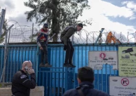 people standing on a fence look at heavy machinery demolishing a structure inside the headquarters of the united nations relief and works agency unrwa in the sheikh jarrah neighbourhood of israeli annexed east jerusalem on january 20 2026 photo afp