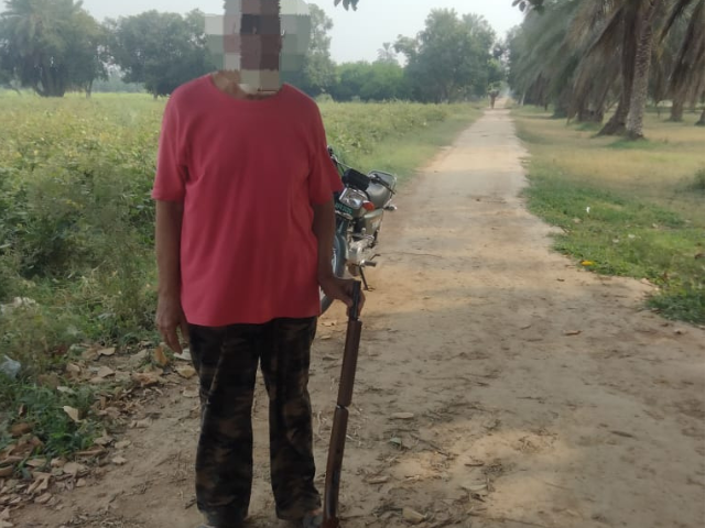 A suspected hunter with a seized firearm during Punjab Wildlife Department action against illegal hunting of falcons and quails. Photo: Express