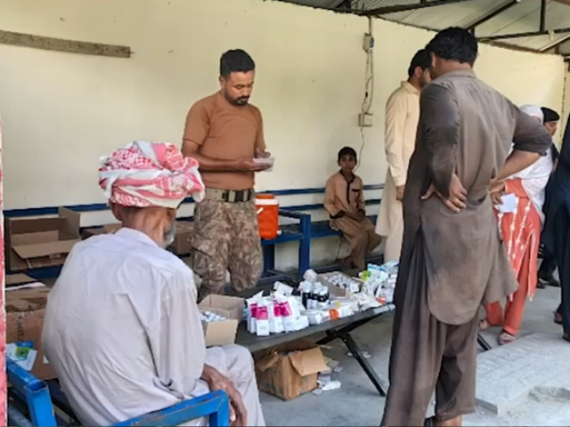 Patients line up for medical assistance at a health camp. Photo: Express