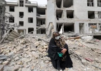 a woman sits outside her destroyed apartment after it was damaged by an airstrike while she was inside amid the u s  israeli conflict with iran in tehran iran march 12 2026 photo reuters