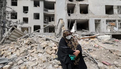 a woman sits outside her destroyed apartment after it was damaged by an airstrike while she was inside amid the u s  israeli conflict with iran in tehran iran march 12 2026 photo reuters