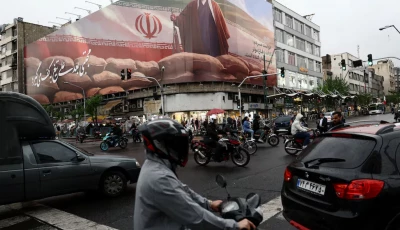 people ride motorcycles near a billboard featuring an image of iran s new supreme leader mojtaba khamenei amid a ceasefire between u s and iran in tehran iran april 20 2026 photo reuters