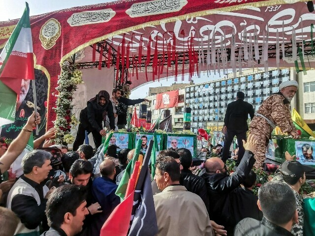 Mourners stand next to the coffin of Iranian Revolutionary Guards commander Hossein Salami (C), and other military commanders and civilians killed during Israeli strikes on the first day of the war, during their funeral procession at Enqelab Square in Tehran on June 28, 2025. — AFP