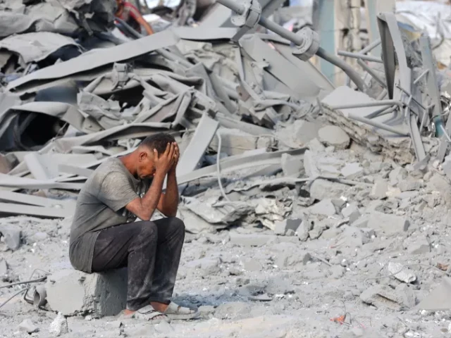 a palestinian man reacts to the destruction after an israeli strike on the sheikh radwan health centre run by the united nations relief and works agency for palestine refugees unrwa in the north of gaza city on august 6 2025 photo afp